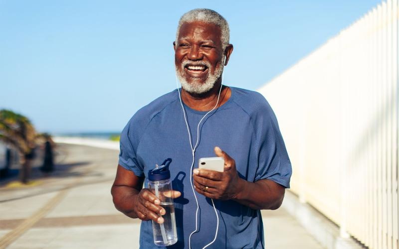 a man holding a water bottle while outdoors